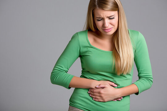 Woman experiences stomach pain in indoor setting