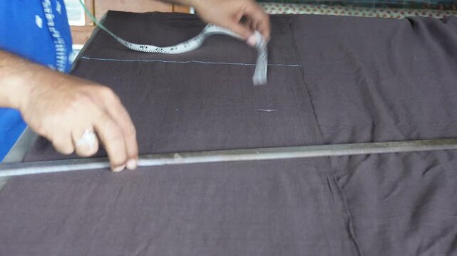 Tailor measuring fabric for precise dress cutting