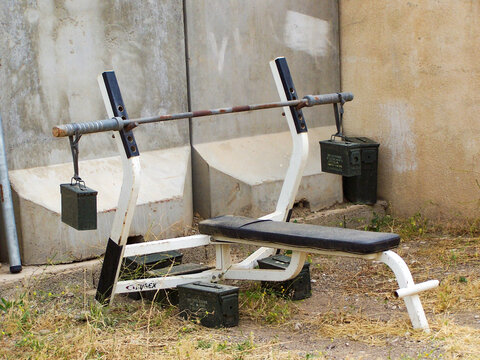 Homemade gym equipment in front of a blast barrier at a US State Department site in Kirkuk, Iraq, during Operation Iraqi Freedom