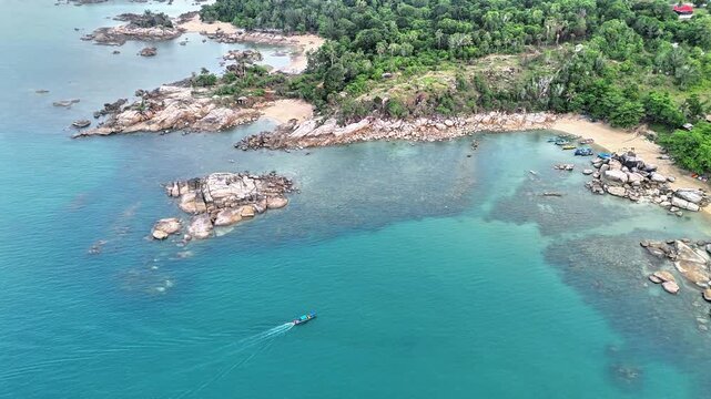 Aerial Cinematic Landscape of Turun Aban Sungailiat Bangka with Rocky Granite Islands, Blue Tropical Sea and Untouched Coastal Environment