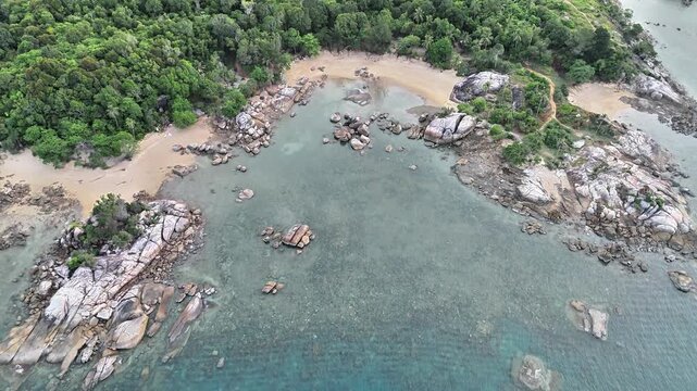 Aerial Drone View of Teluk Karang Beach Sungailiat Bangka Showcasing Granite Bays Crystal Clear Water Tropical Forest and Scenic Coastal Paradise