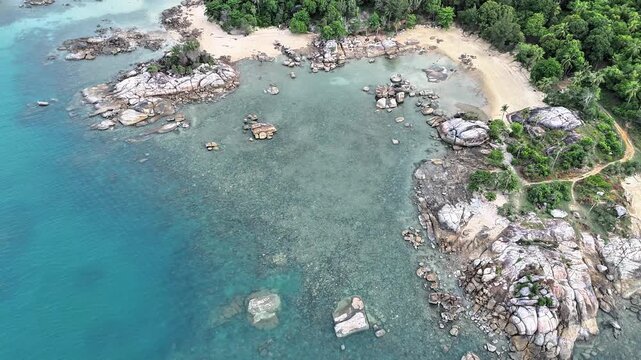 Cinematic Drone Footage of Teluk Karang Sungailiat Showcasing Granite Rocks Sandy Beaches Shallow Ocean and Untouched Island Landscape Beauty