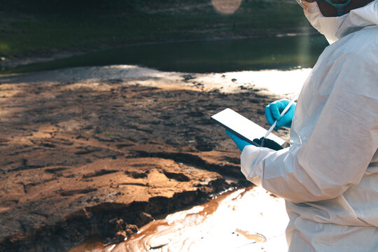 Experts conduct water quality checks and analysis to record data on tablets.