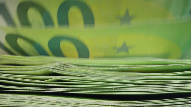 Euro banknotes counted by an automatic cash counting machine. Business investment, corporate finance, capital allocation and long-term financial growth concept.