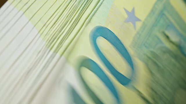 Macro view of automatic counting of euro banknotes illustrating healthy business cash flow, liquidity management, financial planning and corporate operations.