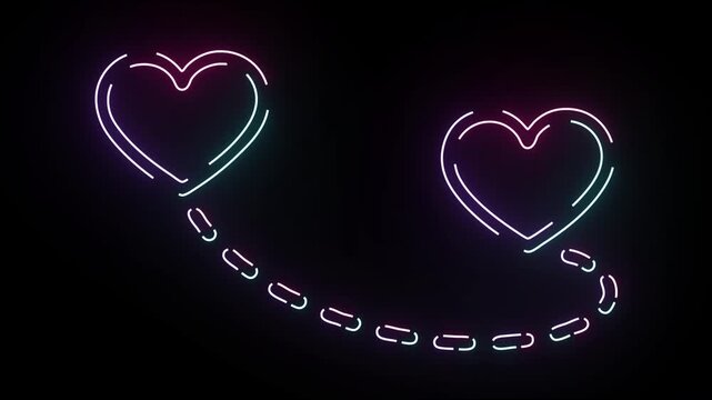 Glowing neon hearts connected by a dotted line of light shimmering with pink and cyan colors on a black background for valentines day concept