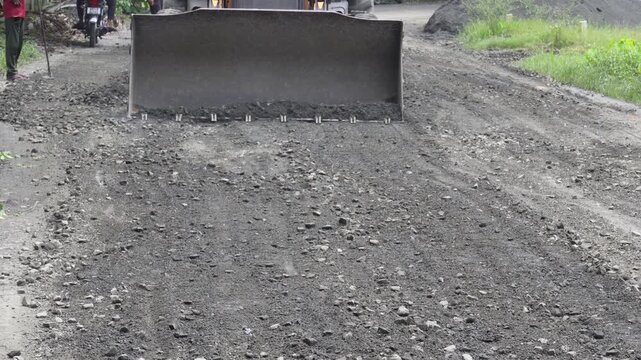 Excavator performing road maintenance work