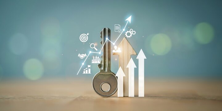 Real estate investment growth concept with rising property models. Financial success and wealth building using miniature house assets on wooden table.