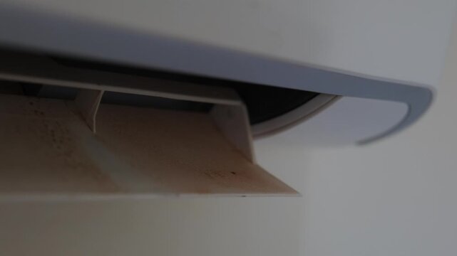 Air conditioner showing signs of wear and moisture buildup, close up of indoor cooling unit highlighting maintenance, cleaning and repair concept