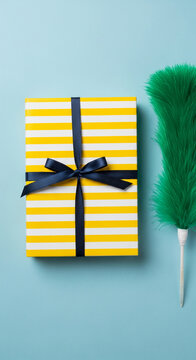 A striped yellow and white gift box with a navy ribbon sits next to a green duster, symbolizing preparedness and celebration