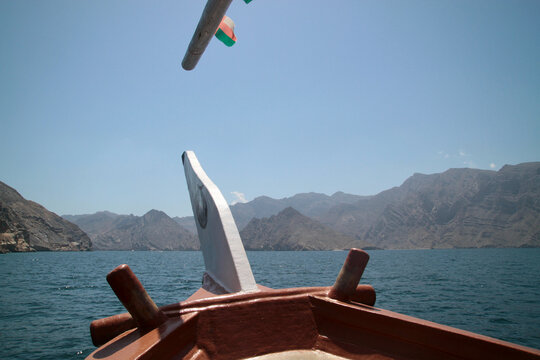 View from bow of traditional dhow crossing Khor Ash Sham fjord, Musandam, Oman