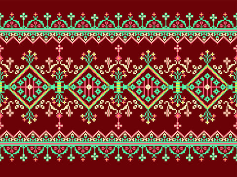 Traditional pixel folk textile pattern featuring symmetrical floral diamond motifs, ornamental borders, and geometric decoration in rich red, turquoise, cream, and pink tones. Seamless ethnic-inspired