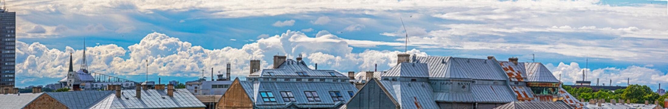 Beautiful panorama of cumulus clouds illuminated by the sun over the Masandra roofs in the city