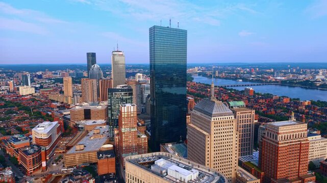 Rising over the Back Bay neighborhood in Boston, Massachusetts. View on the sleek, reflective blue-glass 200 Clarendon tower in the center of image.