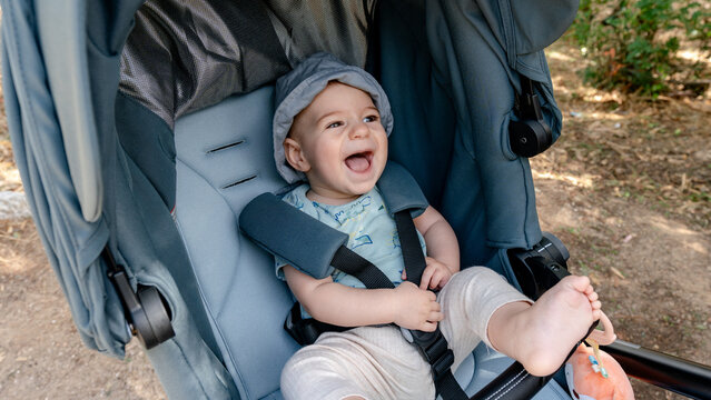 Joyful baby in stroller exploring Sierra de Andujar