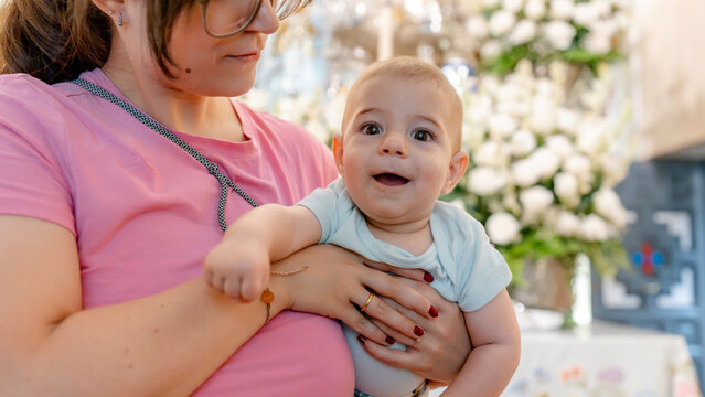 Mother with baby in historic Spanish sanctuary setting