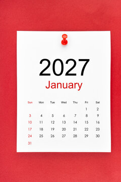 January 2027 calendar page with push pin on red color background.