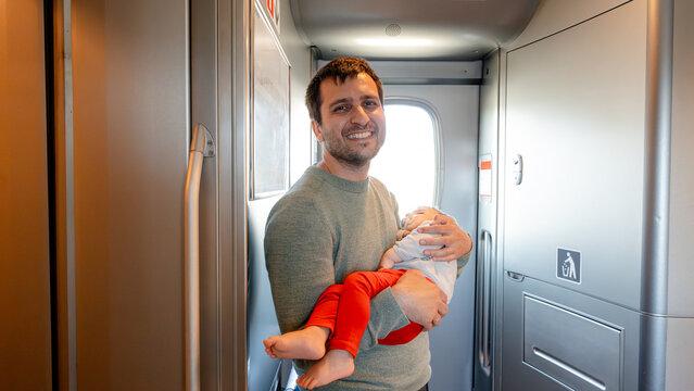Father holding baby on bullet train ride in Japan