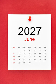 June 2027 calendar page with push pin on red color background.