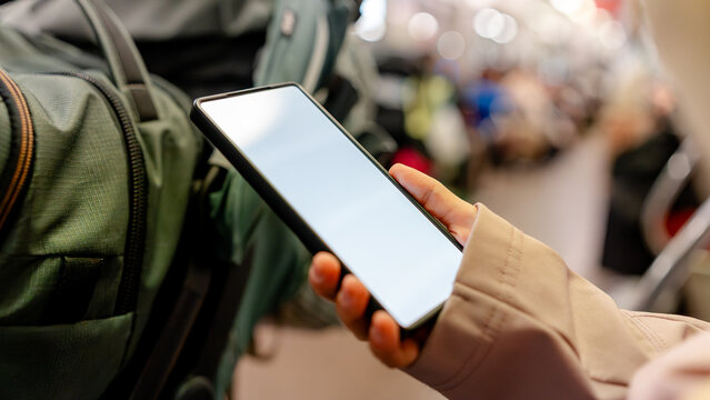 Tourist using smartphone on Kyoto subway train