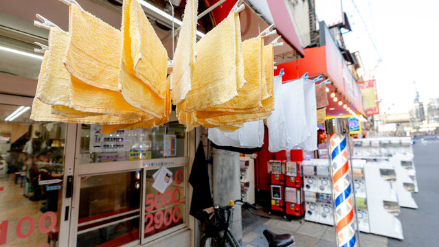 Towels drying outside a barbershop on Shinsekai Hondori