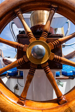 Wooden ship wheel on a Mediterranean  sailboat
