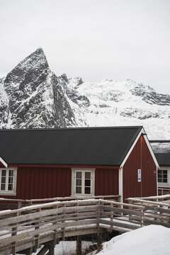 Lofoten Islands winter cabin with snowy mountains