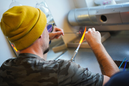 Man crafting glass near Lofoten Islands in winter