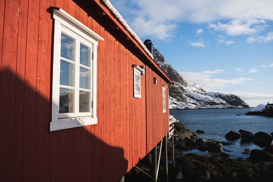 Scenic winter view of red cabin on Lofoten Islands coast