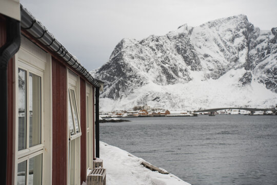 Snowy cabin by the fjord in the Lofoten Islands