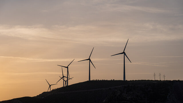 Wind turbines on a hill at sunset in Spain