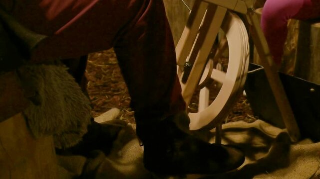 Artisan Spinning Wool with Traditional Wooden Tool at Christmas Fair