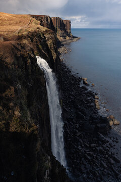 Mealt Falls waterfall plunging into the sea, Isle of Skye