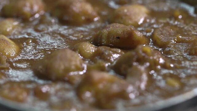 Extreme close up shot of authentic Amritsari chole showcasing rich gravy and chickpea texture.