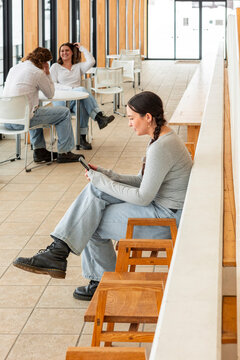 Students relaxing between classes in modern campus
