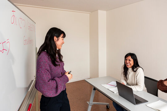 Adult Japanese lesson with teacher and student in classroom