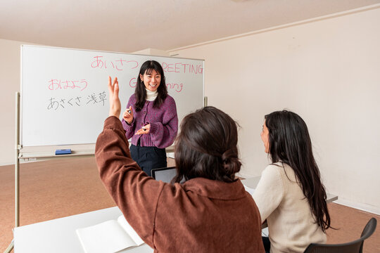 Adult Japanese lesson with teacher and student in classroom