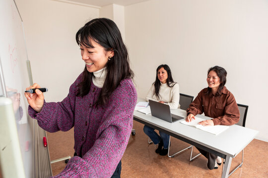 Adult Japanese lesson in classroom with teacher and student