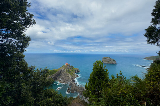 peaceful and serene coastal view of a lighthouse perched on rocky cliffs overlooking the ocean from a high vantage point, capturing the tranquil beauty of natural scenery with vibrant blue.