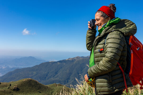 Woman hiker enjoying mountain view at Yehliu Geopark