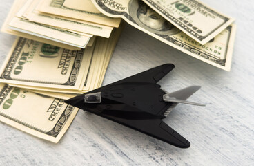 Obraz premium military miniature toy airplane on dollars background
