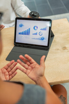 Business meeting with tablet showing AI analytics dashboard