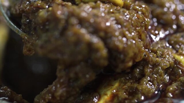 Detailed macro shot of traditional Indian mango pickle showcasing rich texture and vibrant colours.