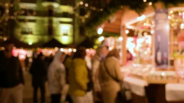 Blurred Christmas Market with Festive Bokeh and People Walking