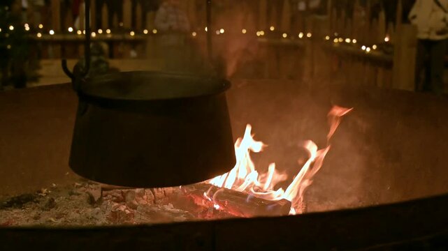Burning Firewood and Boiling Pot Creating Cozy Christmas Market Atmosphere