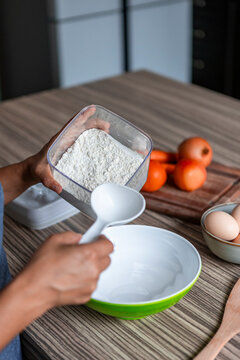 Woman measuring flour to make handmade pasta at home kitchen