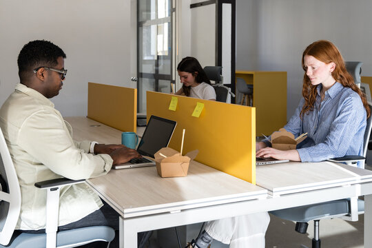 Modern coworking space with diverse team working quietly