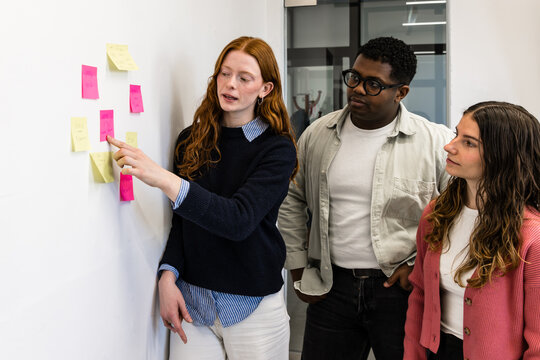Team brainstorming with sticky notes during agile workshop