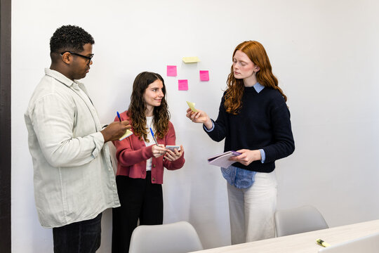 Team planning session with sticky notes in modern office