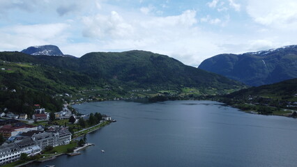 Fototapeta premium Aerial view of Norwegian fjord surrounded by mountains near Bergen